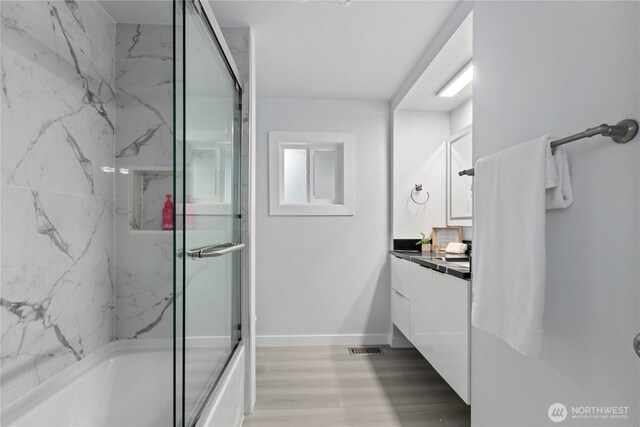 4530 240th St SW, Mountlake Terrace, WA 98043 - full bathroom featuring vanity, shower / bath combination with glass door, baseboards, and wood finished floors