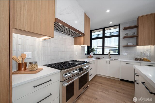 8004 39th Ave SW, Seattle, WA 98136 - kitchen featuring double oven range, a sink, backsplash, light countertops, and light wood-style floors