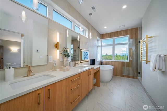 8004 39th Ave SW, Seattle, WA 98136 - bathroom with double vanity, a freestanding tub, marble finish flooring, a towel warming rack, and a stall shower