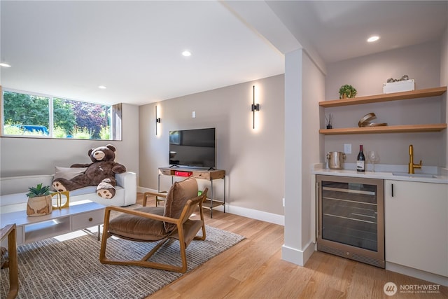 8004 39th Ave SW, Seattle, WA 98136 - living room with beverage cooler, a bar, light wood finished floors, recessed lighting, and baseboards