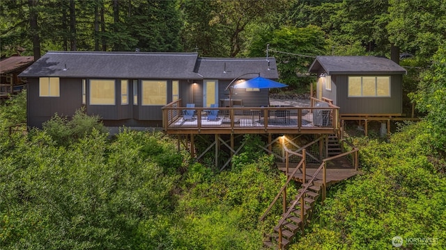 1188 Island Dr, Lummi Island, WA 98262 - back of house featuring stairway, a wooden deck, a view of trees, and roof with shingles