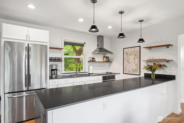 1188 Island Dr, Lummi Island, WA 98262 - kitchen with open shelves, freestanding refrigerator, wall chimney exhaust hood, dark countertops, and a sink