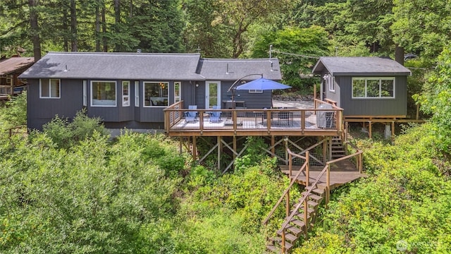 1188 Island Dr, Lummi Island, WA 98262 - back of property with stairway, a wooden deck, roof with shingles, and a view of trees