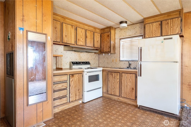 131 Victoria Loop NE, Ocean Shores, WA 98569 - kitchen with white appliances, ventilation hood, a sink, brown cabinetry, and light countertops