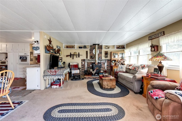 25513 37th Ave E, Spanaway, WA 98387 - living area featuring a wood stove and carpet flooring