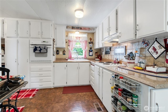 25513 37th Ave E, Spanaway, WA 98387 - kitchen featuring white appliances, under cabinet range hood, a sink, white cabinets, and light countertops
