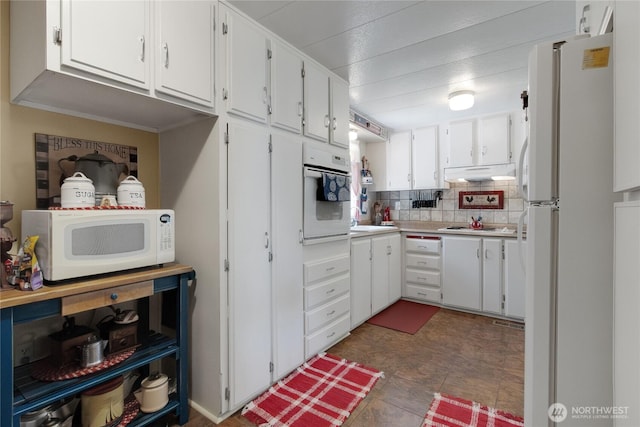 25513 37th Ave E, Spanaway, WA 98387 - kitchen with white appliances, under cabinet range hood, light countertops, white cabinets, and backsplash