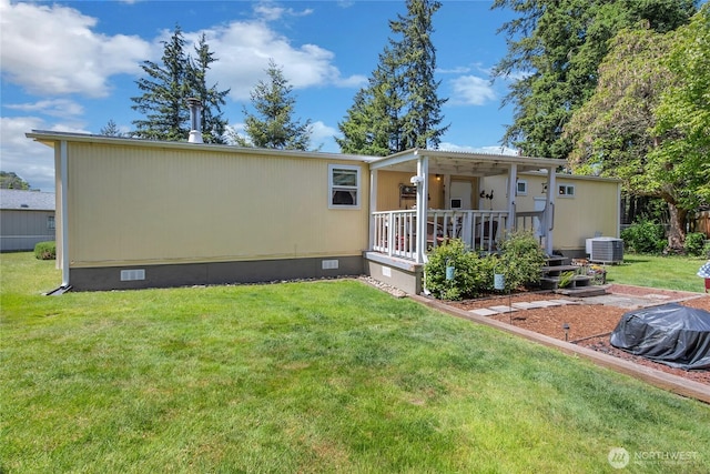 25513 37th Ave E, Spanaway, WA 98387 - back of house with crawl space, a lawn, central AC unit, and a deck