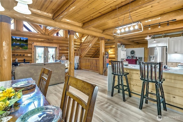 19219 SE 299th Pl, Kent, WA 98042 - dining room featuring rustic walls, wood ceiling with exposed beams, light wood finished floors, stairway, and french doors