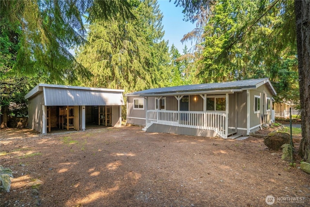 3883 SE Harriet St, Port Orchard, WA 98366 - view of front facade with covered porch, metal roof, and an outbuilding