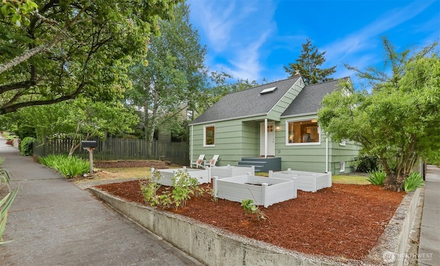 369 NW 49th St, Seattle, WA 98107 - rear view of house featuring a shingled roof and a garden