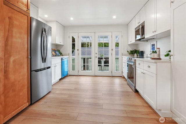 369 NW 49th St, Seattle, WA 98107 - kitchen featuring stainless steel appliances, french doors, light countertops, light wood-style flooring, and recessed lighting