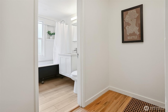369 NW 49th St, Seattle, WA 98107 - full bathroom with wood finished floors, toilet, baseboards, and vanity