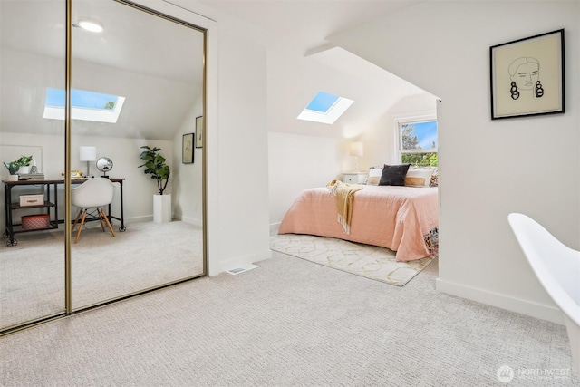 369 NW 49th St, Seattle, WA 98107 - carpeted bedroom with a skylight, vaulted ceiling, a desk, a closet, and baseboards