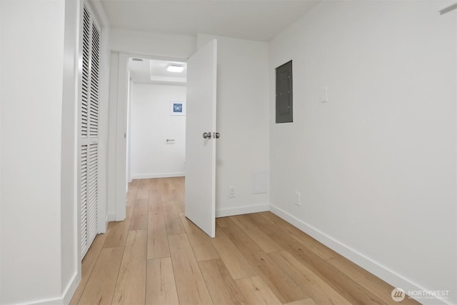 369 NW 49th St, Seattle, WA 98107 - hallway featuring electric panel, light wood finished floors, and baseboards