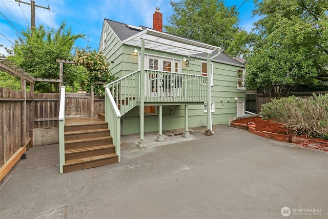369 NW 49th St, Seattle, WA 98107 - rear view of property featuring a chimney, a patio, stairs, roof with shingles, and a wooden deck