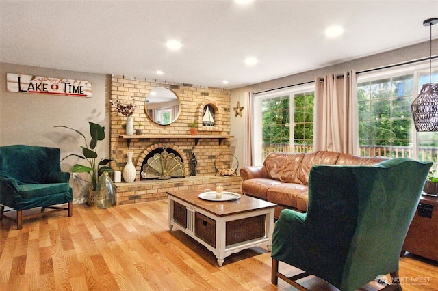 17521 25th Street Ct E, Lake Tapps, WA 98391 - living room featuring light wood finished floors, a brick fireplace, and recessed lighting