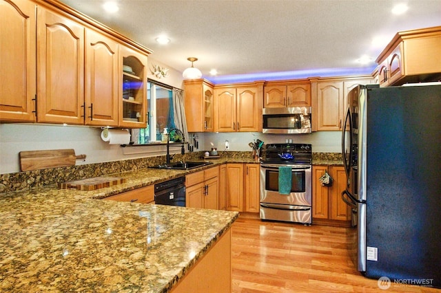17521 25th Street Ct E, Lake Tapps, WA 98391 - kitchen with appliances with stainless steel finishes, a sink, light wood-type flooring, dark stone countertops, and glass insert cabinets