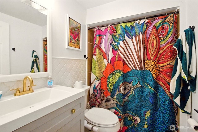 17521 25th Street Ct E, Lake Tapps, WA 98391 - full bathroom with vanity, toilet, wainscoting, and a shower with shower curtain