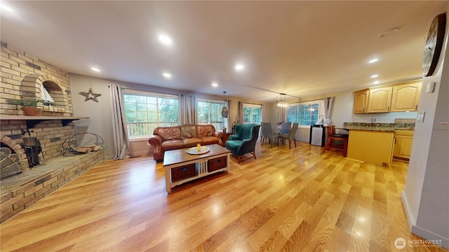 17521 25th Street Ct E, Lake Tapps, WA 98391 - living area with light wood-type flooring, a fireplace, recessed lighting, and baseboards