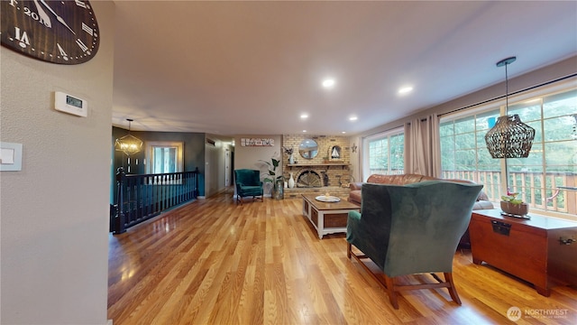 17521 25th Street Ct E, Lake Tapps, WA 98391 - living area with light wood-style floors, recessed lighting, a chandelier, and a fireplace