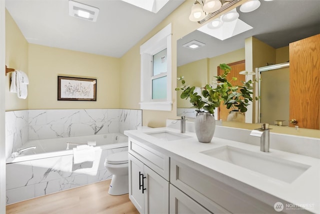 6149 115th Pl SE, Bellevue, WA 98006 - full bathroom featuring a skylight, double vanity, a garden tub, wood finished floors, and a shower stall