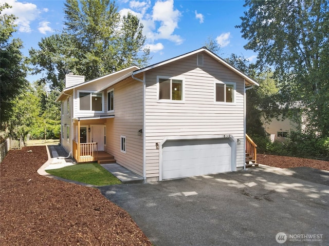 6149 115th Pl SE, Bellevue, WA 98006 - view of side of home with asphalt driveway, an attached garage, and a chimney