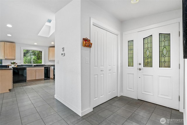573 Klamath Dr, La Conner, WA 98257 - foyer entrance with light tile patterned floors, recessed lighting, a skylight, and baseboards