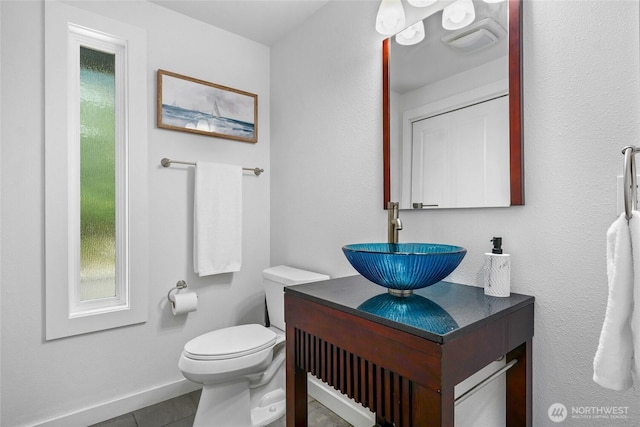 573 Klamath Dr, La Conner, WA 98257 - half bathroom featuring vanity, toilet, tile patterned flooring, and baseboards