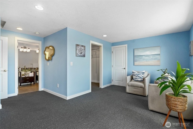 573 Klamath Dr, La Conner, WA 98257 - living area featuring dark colored carpet, baseboards, and recessed lighting
