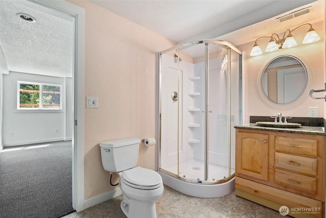 573 Klamath Dr, La Conner, WA 98257 - bathroom featuring a stall shower, a textured ceiling, vanity, toilet, and baseboards