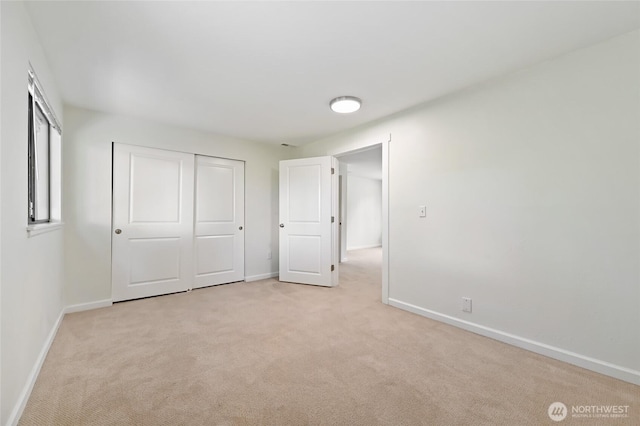 14208 93rd Ave NE, Kirkland, WA 98034 - unfurnished bedroom with light colored carpet, baseboards, and a closet