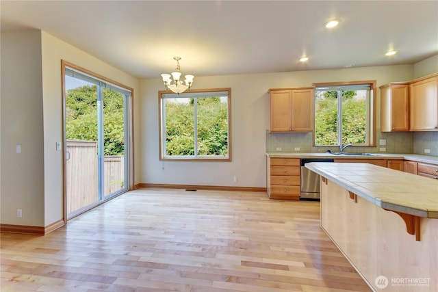 19402 NE 68th Way, Redmond, WA 98052 - kitchen with stainless steel dishwasher, plenty of natural light, a sink, a chandelier, and recessed lighting