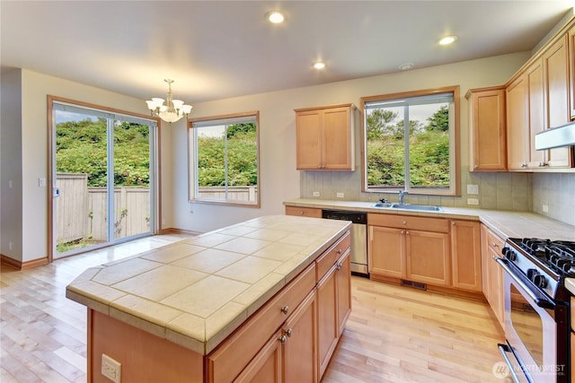 19402 NE 68th Way, Redmond, WA 98052 - kitchen featuring tile countertops, light brown cabinetry, appliances with stainless steel finishes, light wood-style floors, and recessed lighting