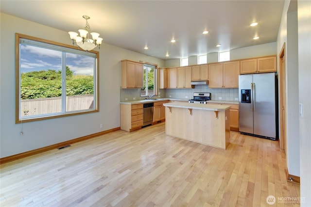 19402 NE 68th Way, Redmond, WA 98052 - kitchen with stainless steel appliances, light countertops, under cabinet range hood, light brown cabinets, and recessed lighting