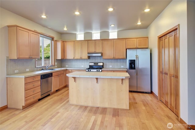 19402 NE 68th Way, Redmond, WA 98052 - kitchen with appliances with stainless steel finishes, a center island, under cabinet range hood, light brown cabinets, and recessed lighting