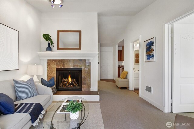 9512 1st Ave NE Unit 402, Seattle, WA 98115 - living area with a tiled fireplace, carpet floors, and baseboards