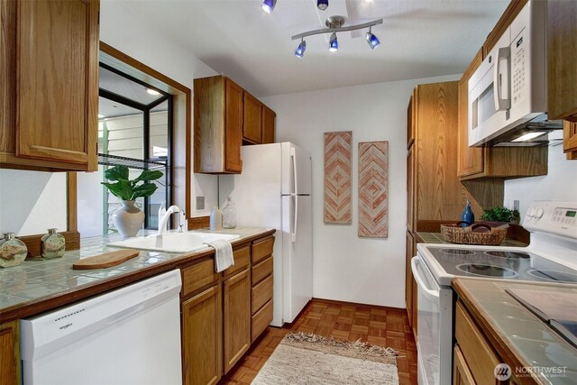 9512 1st Ave NE Unit 402, Seattle, WA 98115 - kitchen featuring white appliances, tile countertops, a sink, and brown cabinets