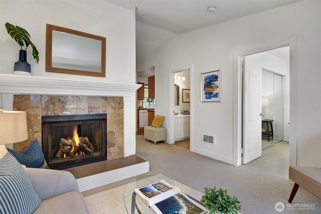 9512 1st Ave NE Unit 402, Seattle, WA 98115 - living area featuring carpet floors, a premium fireplace, baseboards, and lofted ceiling