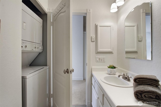9512 1st Ave NE Unit 402, Seattle, WA 98115 - bathroom featuring stacked washer / dryer and vanity