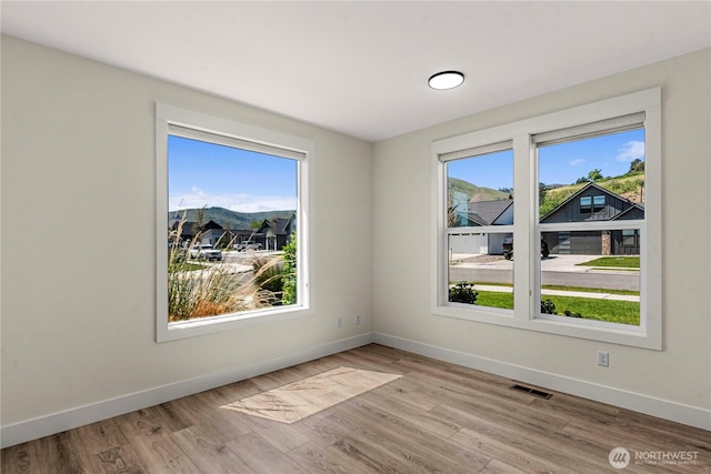 1007 Racine Springs Dr, Wenatchee, WA 98801 - unfurnished room with healthy amount of natural light, baseboards, and light wood-type flooring