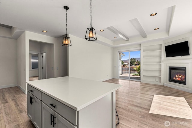 1007 Racine Springs Dr, Wenatchee, WA 98801 - kitchen with open floor plan, gray cabinetry, light wood-style floors, light countertops, and a center island