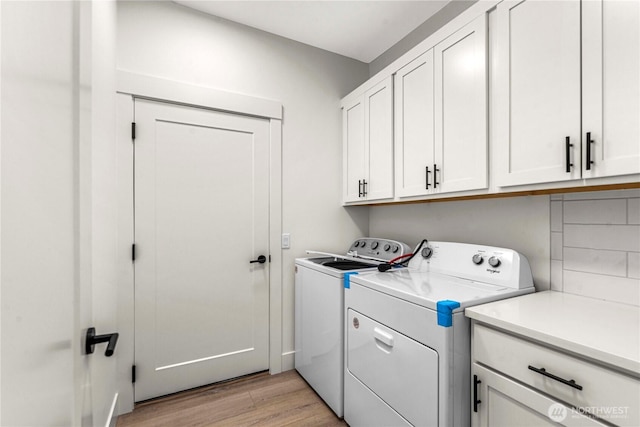 1007 Racine Springs Dr, Wenatchee, WA 98801 - washroom featuring separate washer and dryer, cabinet space, and light wood-type flooring