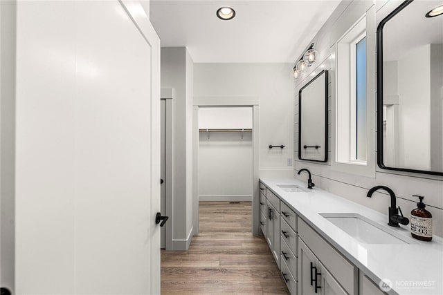 1007 Racine Springs Dr, Wenatchee, WA 98801 - bathroom with double vanity, recessed lighting, wood finished floors, baseboards, and a spacious closet