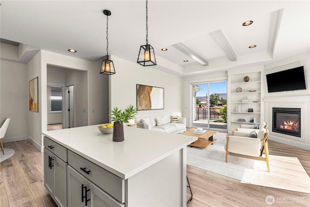 1007 Racine Springs Dr, Wenatchee, WA 98801 - kitchen featuring open floor plan, gray cabinetry, light wood-style flooring, a kitchen island, and light countertops