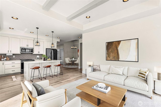 1007 Racine Springs Dr, Wenatchee, WA 98801 - living room featuring recessed lighting, light wood-style floors, a chandelier, baseboards, and beam ceiling