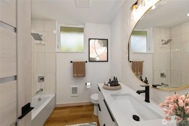 4306 S Holden St, Seattle, WA 98118 - full bathroom with vanity, wood finished floors, toilet, and healthy amount of natural light
