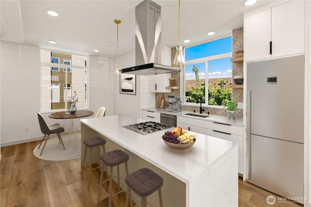4306 S Holden St, Seattle, WA 98118 - kitchen featuring island range hood, appliances with stainless steel finishes, a sink, open shelves, and white cabinetry