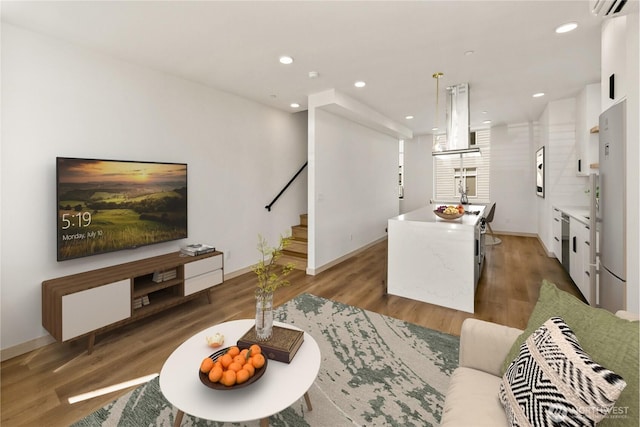 4306 S Holden St, Seattle, WA 98118 - living room featuring stairway, wood finished floors, baseboards, recessed lighting, and a wall mounted AC