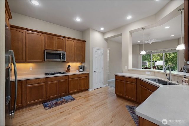 4972 Spokane St NE, Lacey, WA 98516 - kitchen featuring stainless steel microwave, light wood-style floors, light countertops, hanging light fixtures, and recessed lighting